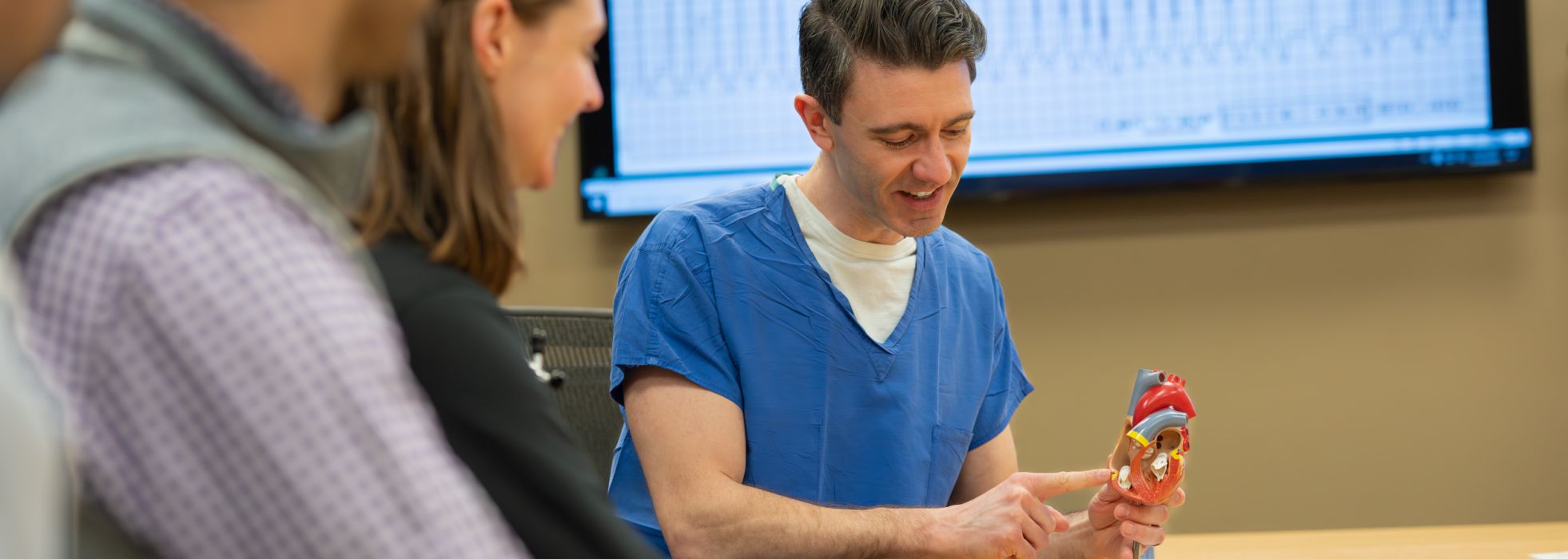 Dr. Blake Fleeman points to a spot on a model of the human heart