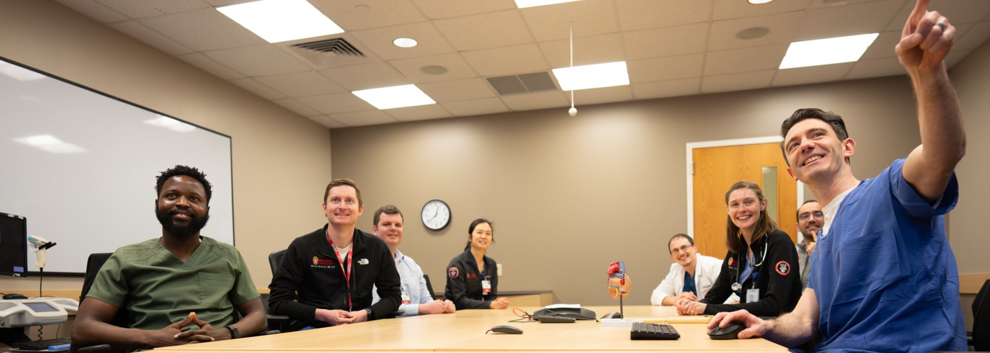 Cardiology faculty and fellows in a classroom.