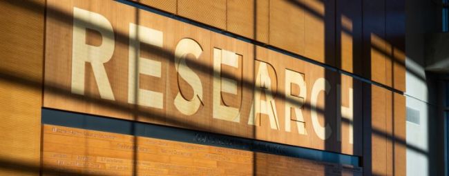 Research signage on a wooden wall