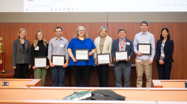 Education Day award winners pose with their plaques.