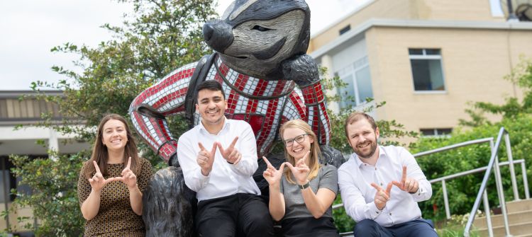 Haley Probst, Mazen Almasry, Geralyn Palmer, and Lucas Fass in front of a Bucky Badger statue