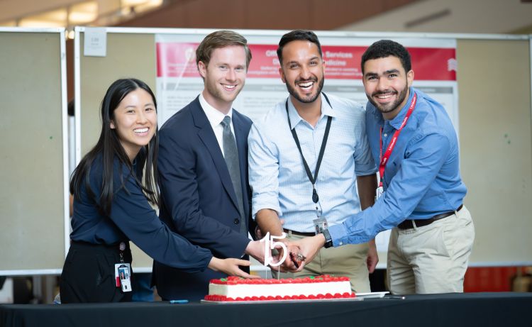 Four internal medicine residents shared in the ceremonial cutting of a cake in celebration of the 15th anniversary of Research Day. L-R: Jeanette Liou, MD, chief resident; Clayton Skogman, MD, PG-3; Bikrum Chahal, MD, PG-3; and Ahmed El Shaer, MBBS, chief resident.