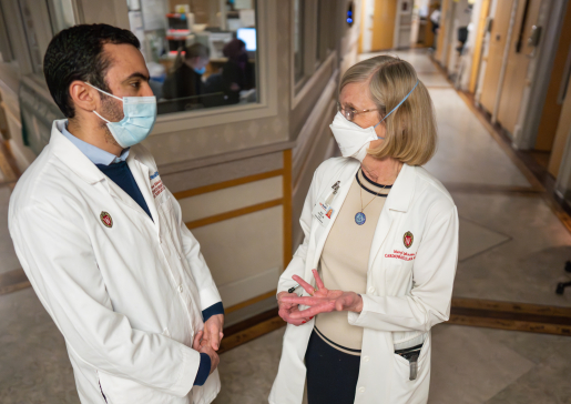 Heart failure cardiologist Dr. Maryl Johnson and fellow Dr. Ahmed Elkhouly talk in a hallway at University Hospital