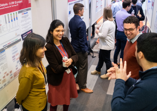 Department faculty at a research poster session