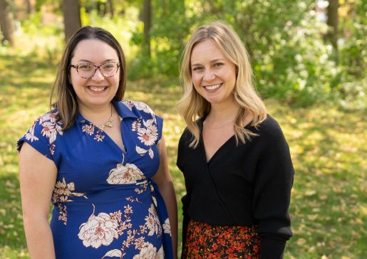 Infectious Disease staff Rachel Filipiak and Erica Mishek standing together outside smiling and looking at the camera